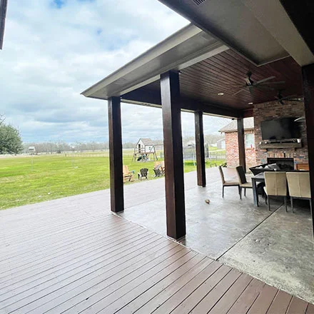 Covered patio and stained deck with outdoor living area